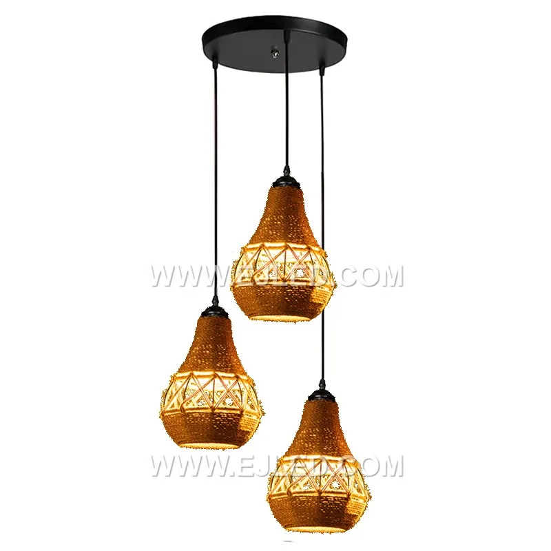 Woven from natural rattan, the RP0042 pendant light features three bell-shaped shades that direct light downwards while diffusing it through their open weave. It is designed for focused illumination over surfaces. - view 2
