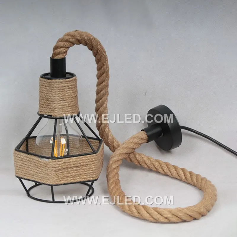 Visible hemp rope wraps the open black iron frame of this basket-shaped pendant. It offers diffuse illumination from a single exposed bulb, creating a rustic and textured lighting element suitable for various spaces.