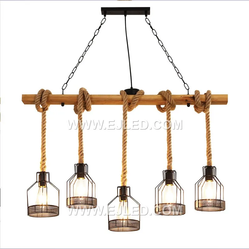 Natural hemp rope is tightly woven around a visible cylindrical wooden frame, forming an enclosed shade. This single-lamp pendant provides a warm, filtered glow, emphasizing natural textures and a rustic aesthetic.