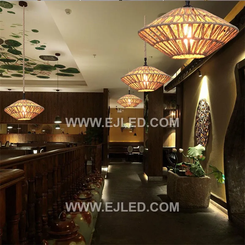 This rattan pendant, RP0079, features a transitional weave, tighter at the top and looser towards the flared open base. It offers both diffused and direct light, with a visible single lamp, making it versatile for various settings. - view 3