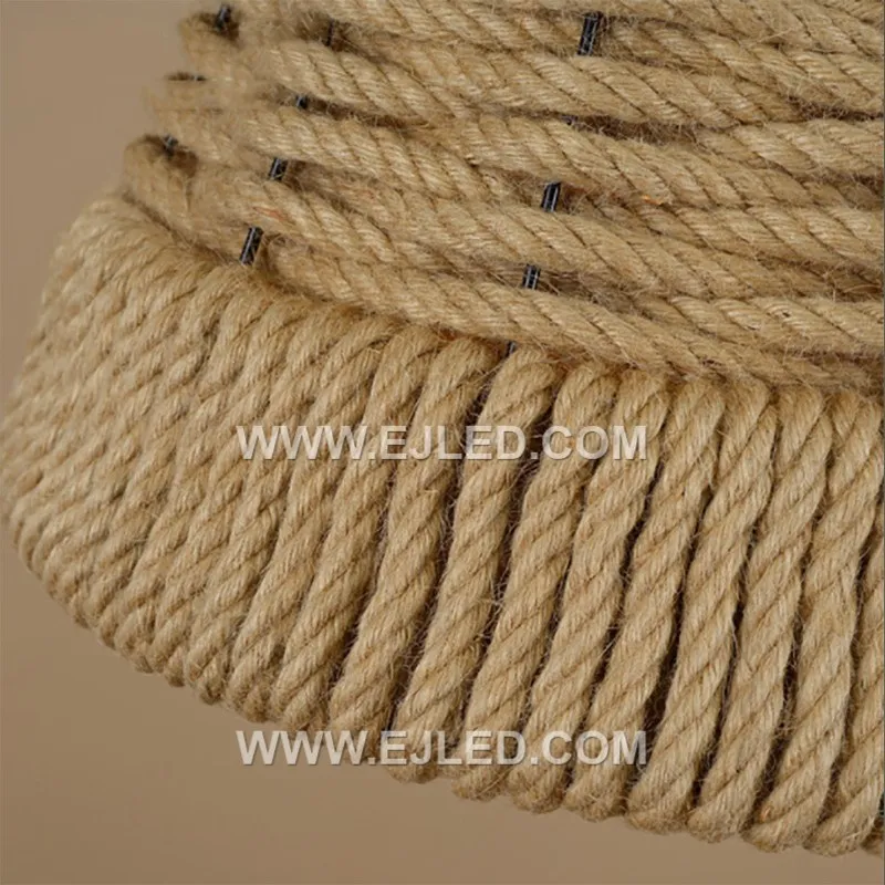 The RP0097 bell pendant, woven from natural rattan with a moderately open structure, offers diffused downward light that minimizes direct glare. Its classic shape and textured material create a warm ambiance while illuminating surfaces below. - view 4