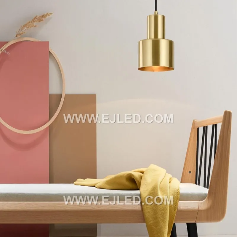 The MK0112 stands out with its tall, narrow cylindrical shade crafted from brass, featuring a distinct brushed brass finish. This clean-lined design offers a focused downlight, differentiating it from wider dome or cone pendants. - view 2