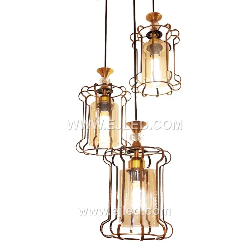 Brass forms the elegant outer cage of this cylindrical pendant light, finished in a subtle gold tone. A clear glass cylinder inside protects the single lamp, creating a clean, focused light suitable for refined interiors.