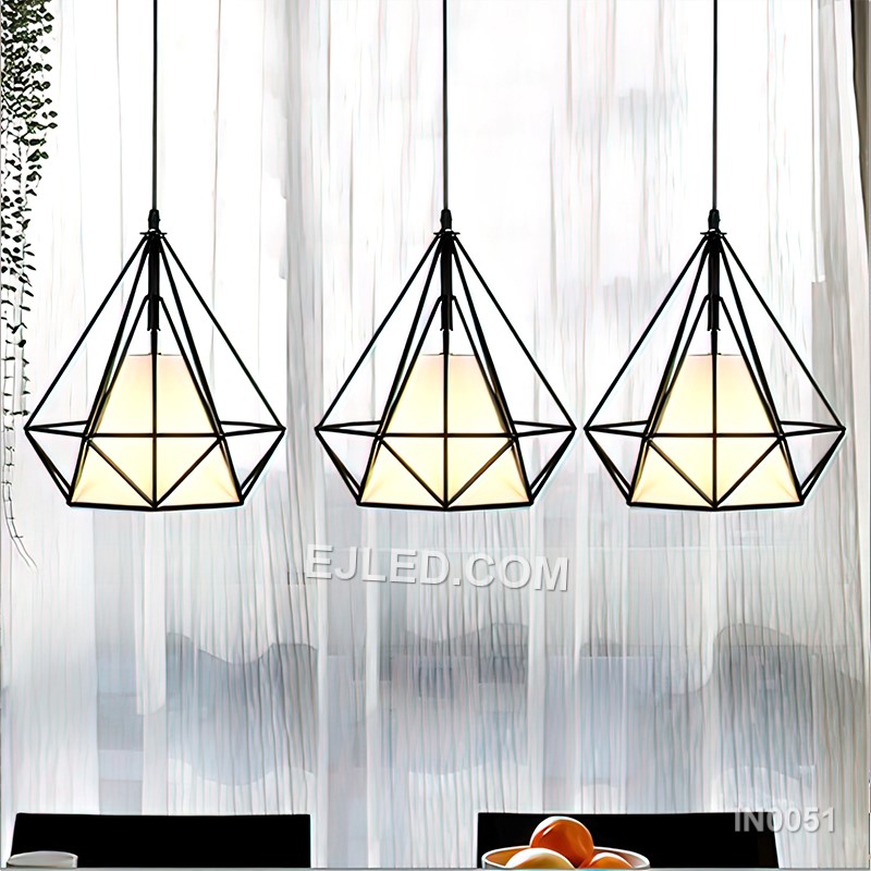 This IN0051 cluster pendant features three black iron diamond-shaped cages, each enclosing a spherical clear glass shade. Suspended at varying heights, it creates a visual centrepiece for rooms with higher ceilings. - view 3