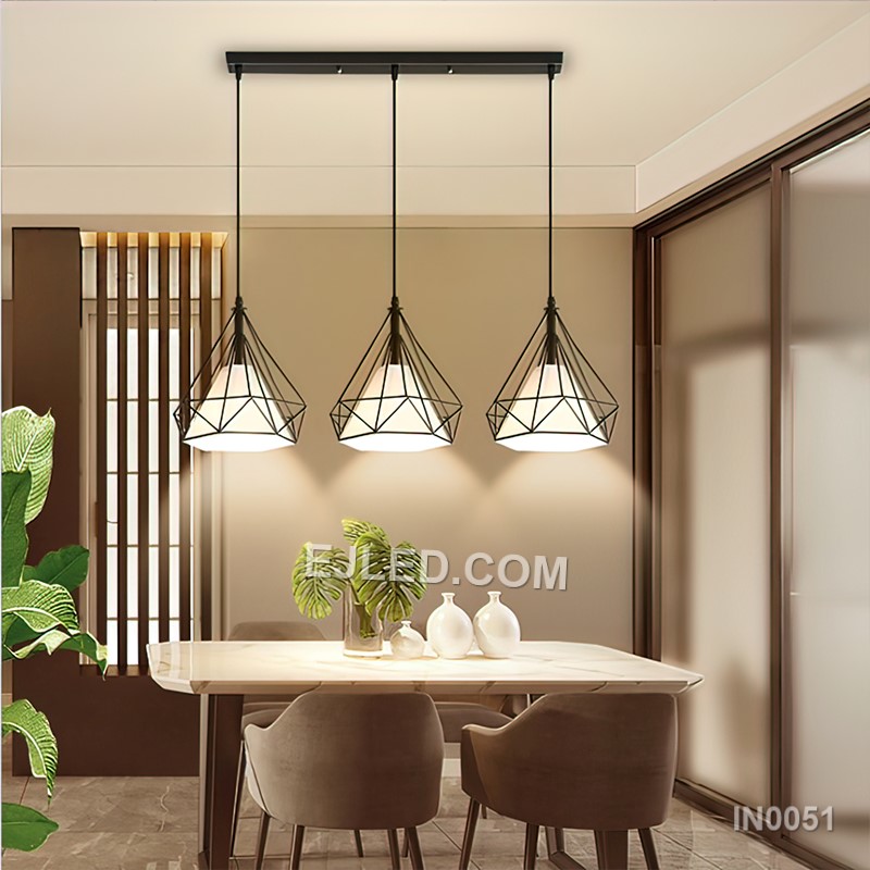 This IN0051 cluster pendant features three black iron diamond-shaped cages, each enclosing a spherical clear glass shade. Suspended at varying heights, it creates a visual centrepiece for rooms with higher ceilings. - view 4