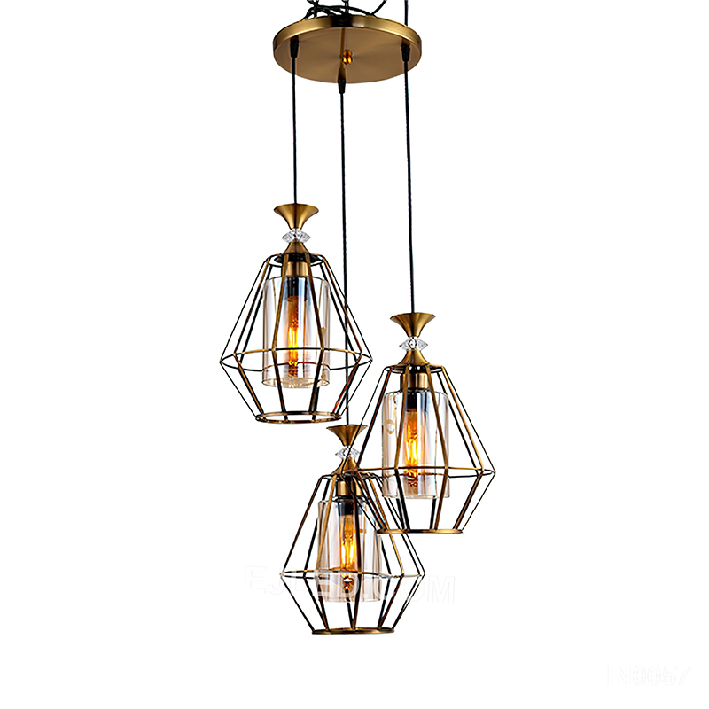 Round silhouettes define this three-light cluster pendant, where each brass-toned cage frames a clear glass globe, directing focused light downwards for general or task illumination. - view 2