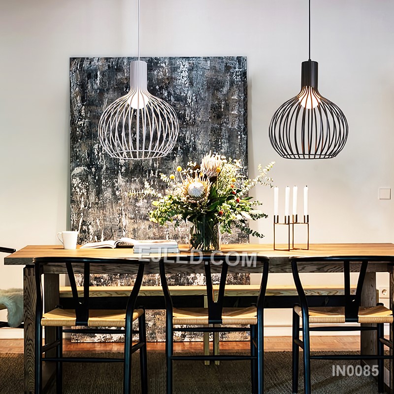 A round, open wire cage defines this single black iron pendant light, designed to cast a soft, ambient glow suitable for dining areas, bar counters, or hotel lobbies. Its simple form allows for versatile placement. - view 5