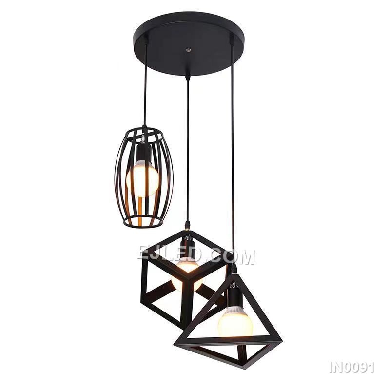 Three open cylindrical black iron cages create a staggered cluster pendant light, each enclosing a single bulb. This fixture provides diffused ambient light and a distinctive visual element for various interiors. - view 2