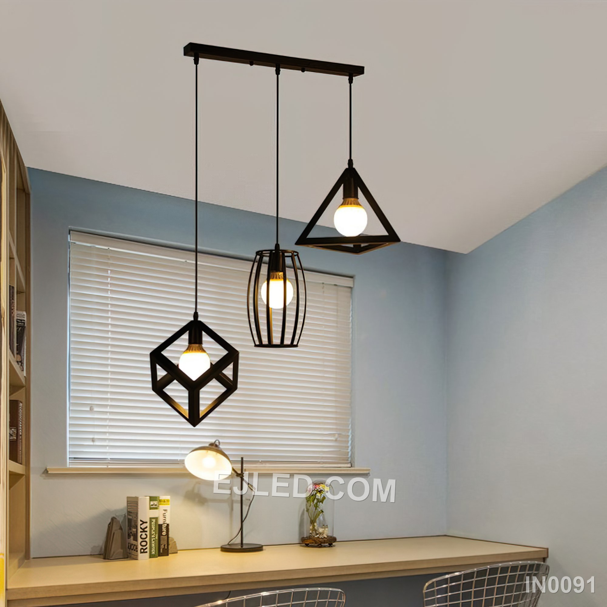 Three open cylindrical black iron cages create a staggered cluster pendant light, each enclosing a single bulb. This fixture provides diffused ambient light and a distinctive visual element for various interiors. - view 4