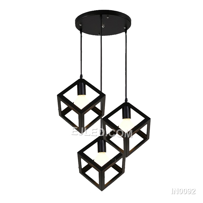 This single pendant light features an open cuboid shade crafted from light-coloured wooden slats, enclosing an inner clear glass cylinder. It offers diffused light and a natural aesthetic.
