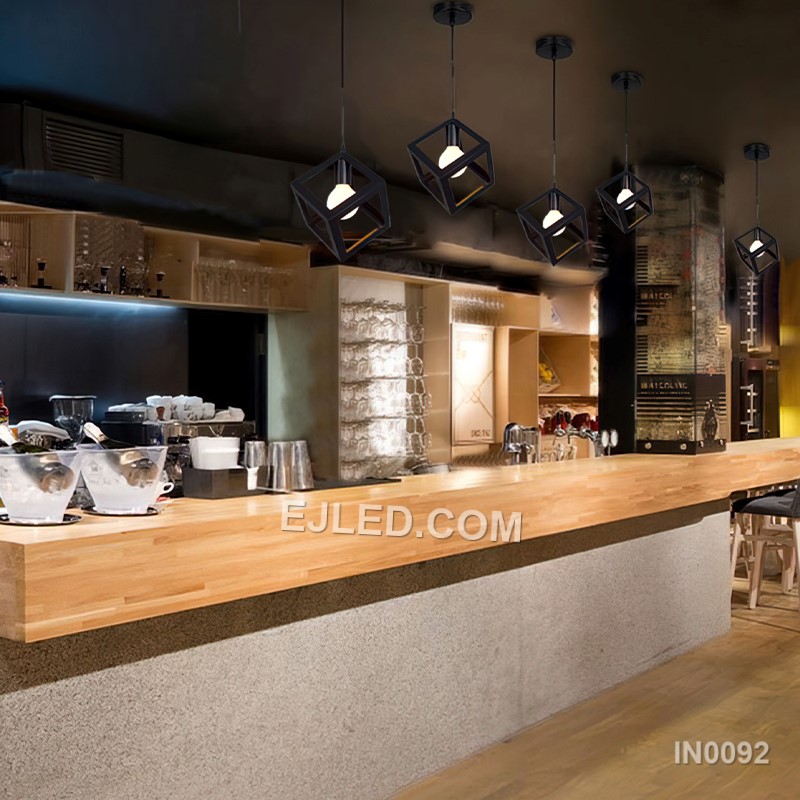 This single pendant light features an open cuboid shade crafted from light-coloured wooden slats, enclosing an inner clear glass cylinder. It offers diffused light and a natural aesthetic. - view 3
