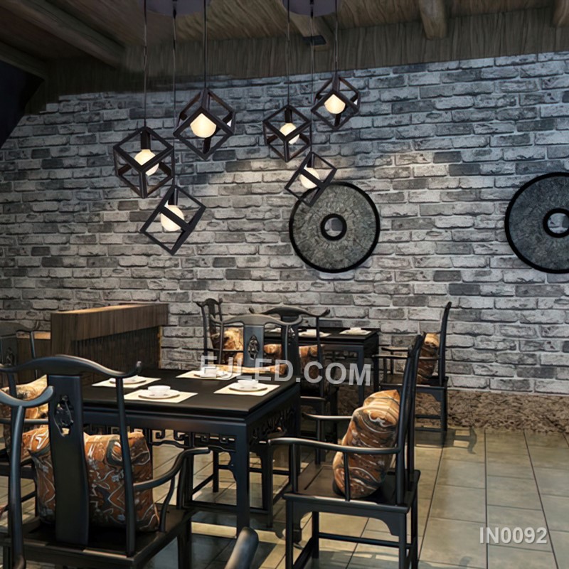 This single pendant light features an open cuboid shade crafted from light-coloured wooden slats, enclosing an inner clear glass cylinder. It offers diffused light and a natural aesthetic. - view 4
