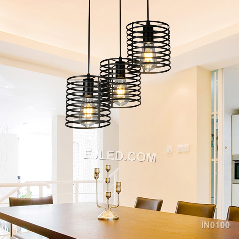 Unlike single-lamp designs, the IN0100 pendant light presents a cluster of three cylindrical black iron wire cages, each enclosing a bulb. This arrangement offers broader light coverage and a more substantial visual presence. - view 4