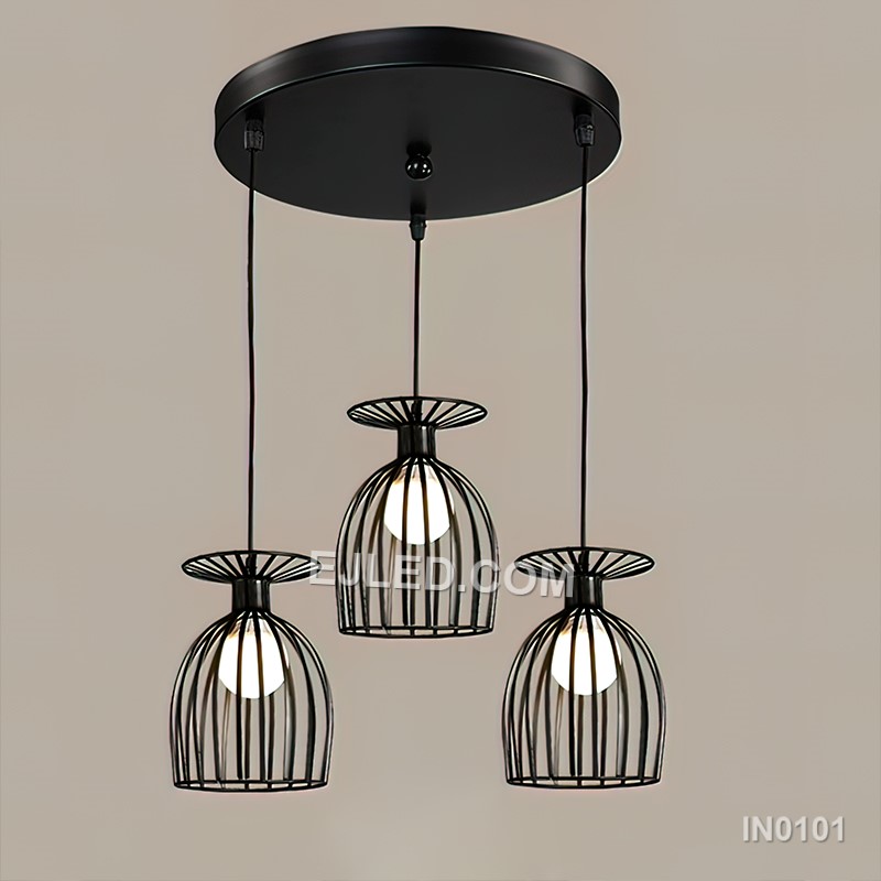 Black iron wire forms three open drum-shaped cages, each housing a single lamp. This multi-lamp pendant hangs from a round canopy, with cords of varying lengths creating a tiered, cluster arrangement.