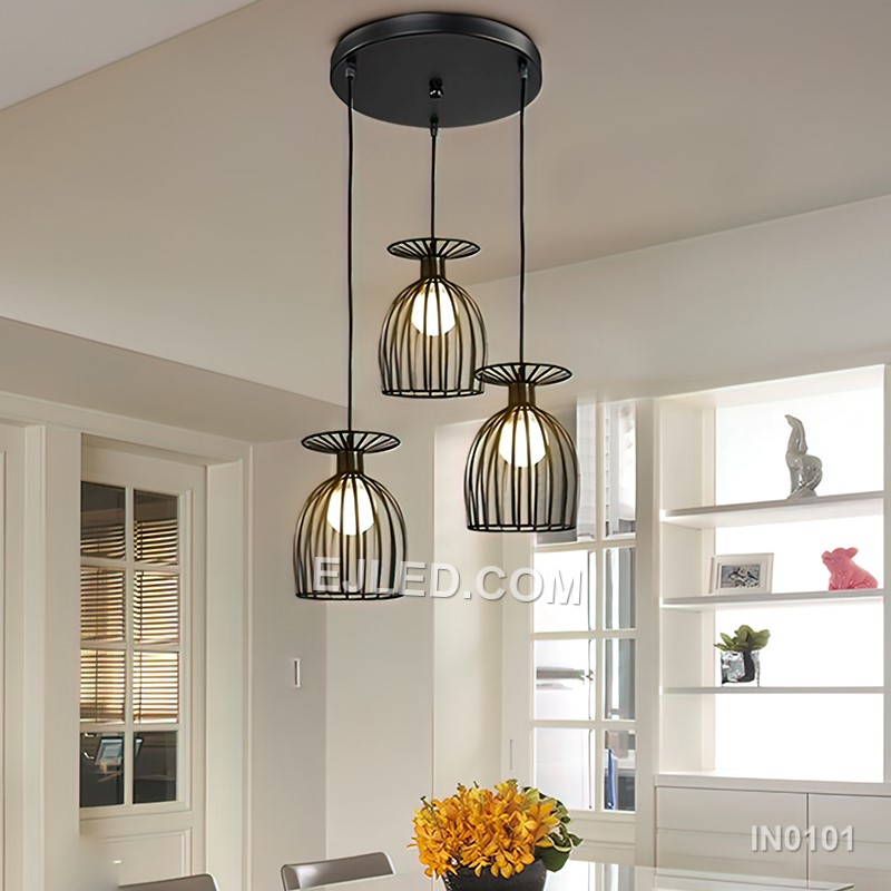 Black iron wire forms three open drum-shaped cages, each housing a single lamp. This multi-lamp pendant hangs from a round canopy, with cords of varying lengths creating a tiered, cluster arrangement. - view 3