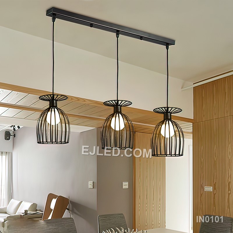 Black iron wire forms three open drum-shaped cages, each housing a single lamp. This multi-lamp pendant hangs from a round canopy, with cords of varying lengths creating a tiered, cluster arrangement. - view 5