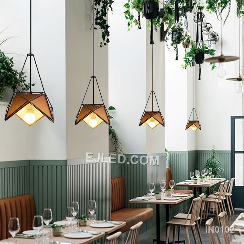 Model IN0102 offers three bell-shaped steel pendant lights, each with an open bottom for directed illumination. Finished in matte black, they suspend from a single rectangular canopy, creating a cohesive lighting solution for linear spaces. - view 3