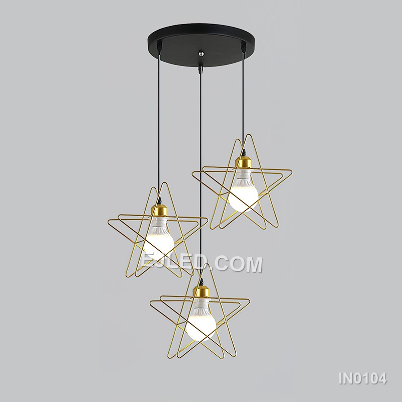 Three cylindrical brass cages form the IN0104 pendant light, each crafted from slender rods. These open frames, suspended from a linear bar, provide an exposed lamp design that diffuses light through the metallic structure. - view 3