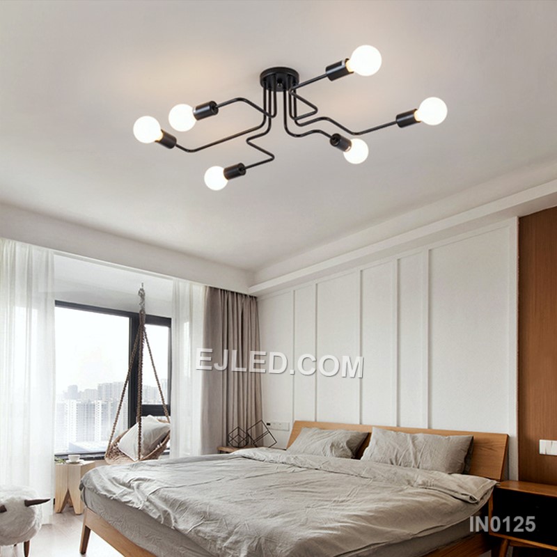 Finished in matte black steel, this close-to-ceiling sputnik fixture offers eight exposed lamp holders on radiating arms. Gold-toned accents at each socket provide visual contrast, making it suitable for spaces needing broad, unshaded illumination without a long drop. - view 5