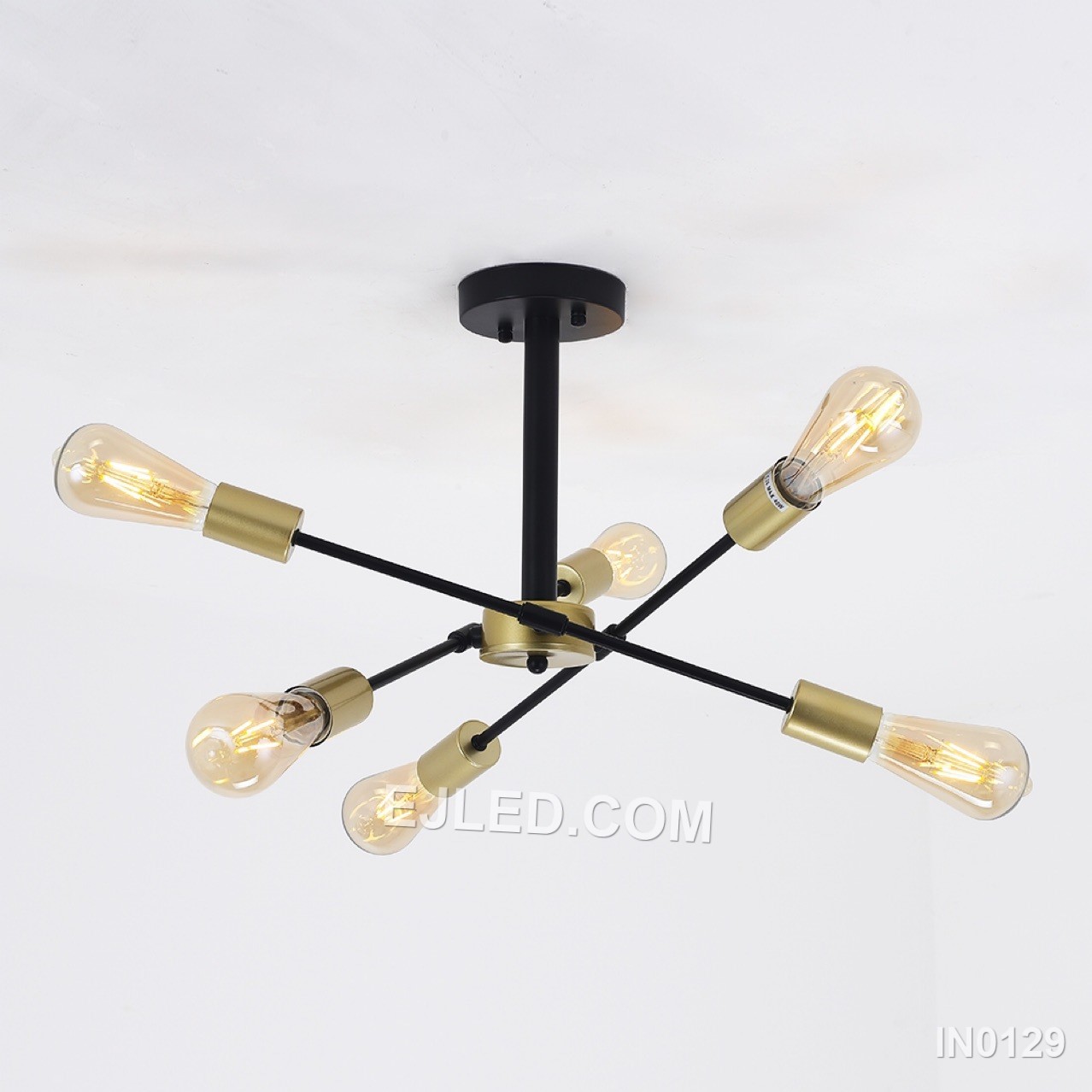 This compact sputnik fixture offers six brass-finished arms radiating from a central sphere, contrasted by black lamp holder collars. A semi-flush mount, it provides wide, unshaded illumination, distinguishing it from larger or suspended sputnik designs for spaces with lower ceilings. - view 2