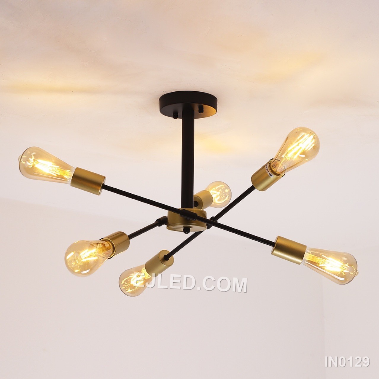 This compact sputnik fixture offers six brass-finished arms radiating from a central sphere, contrasted by black lamp holder collars. A semi-flush mount, it provides wide, unshaded illumination, distinguishing it from larger or suspended sputnik designs for spaces with lower ceilings. - view 3