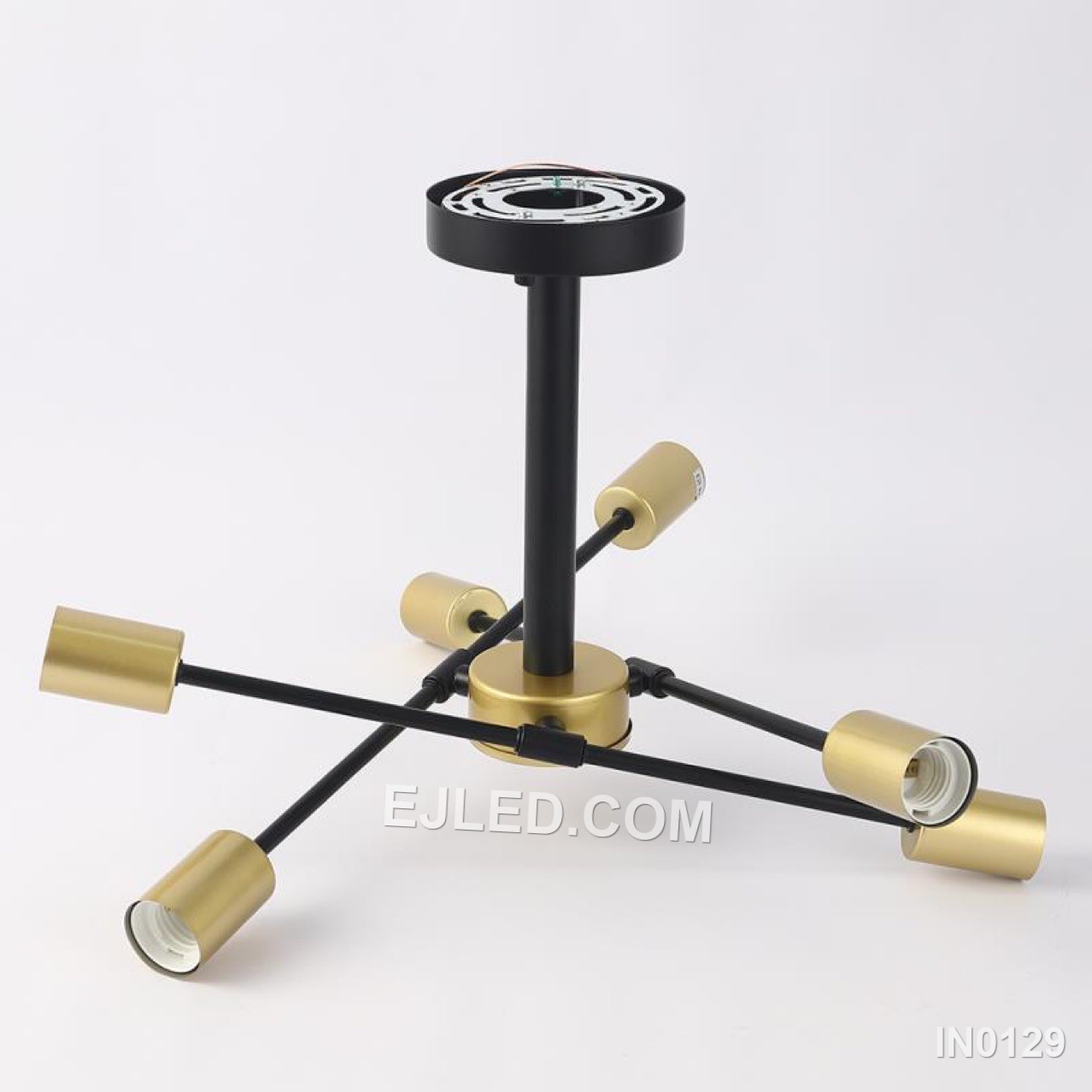This compact sputnik fixture offers six brass-finished arms radiating from a central sphere, contrasted by black lamp holder collars. A semi-flush mount, it provides wide, unshaded illumination, distinguishing it from larger or suspended sputnik designs for spaces with lower ceilings. - view 4
