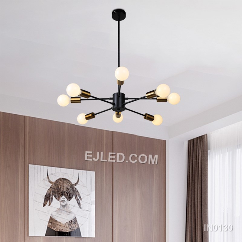 The IN0130 pendant light presents a large, 12-lamp sputnik design, ideal for substantial spaces. Its black steel body and radiating arms, each accented with a gold-toned collar, provide extensive, multi-directional illumination. This fixture hangs by a single cable from a matching black ceiling rose. - view 5