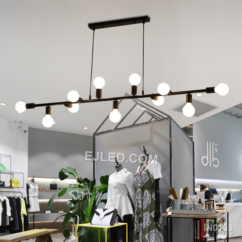 Steel construction defines the IN0135, a large rectangular open-frame pendant light. Eleven lamps radiate from two internal axes, providing extensive, multi-directional illumination. Its matte black finish creates a consistent, contemporary aesthetic. - view 2