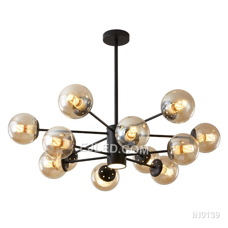 A substantial brass sputnik chandelier, the IN0139 features twelve clear glass globes radiating from a central sphere. This circular form provides broad illumination suitable for large rooms or grand entryways, creating a striking focal point.
