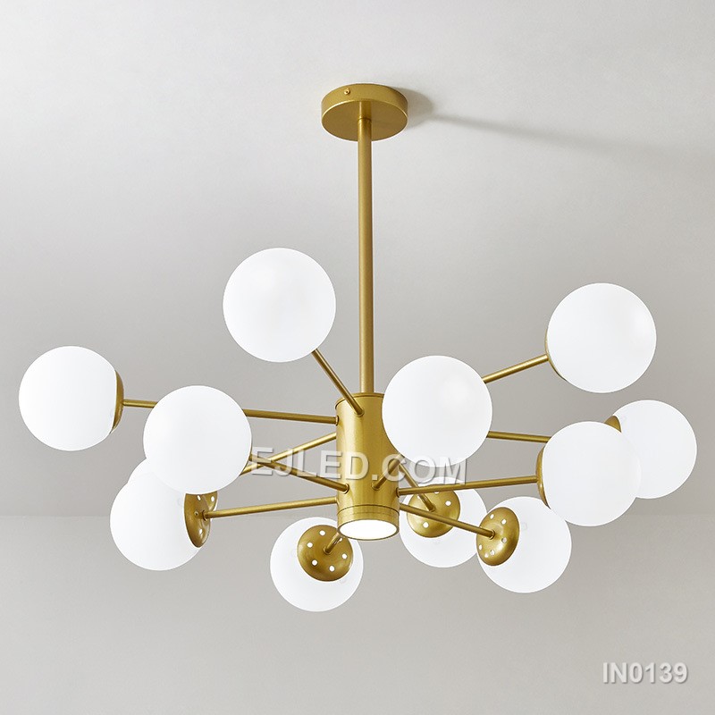 A substantial brass sputnik chandelier, the IN0139 features twelve clear glass globes radiating from a central sphere. This circular form provides broad illumination suitable for large rooms or grand entryways, creating a striking focal point. - view 2