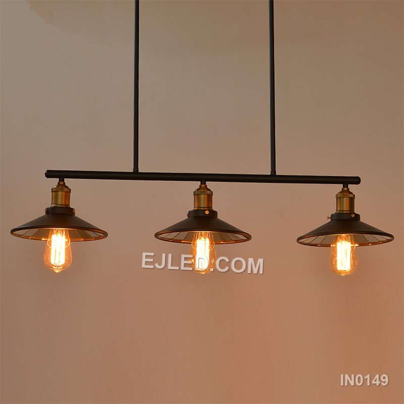 A linear steel pendant, the IN0149 features three individual barrel-shaped shades crafted from black perforated metal. Mounted along a horizontal bar, these unique enclosures diffuse light while casting subtle patterns, distinguishing it from open-cage designs. - view 2