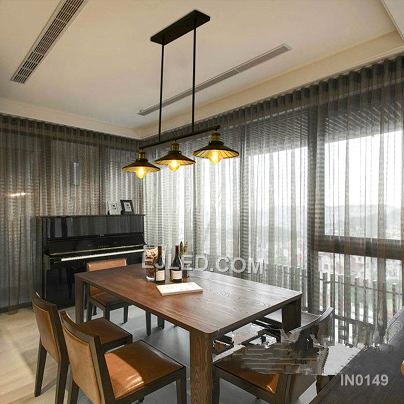 A linear steel pendant, the IN0149 features three individual barrel-shaped shades crafted from black perforated metal. Mounted along a horizontal bar, these unique enclosures diffuse light while casting subtle patterns, distinguishing it from open-cage designs. - view 3