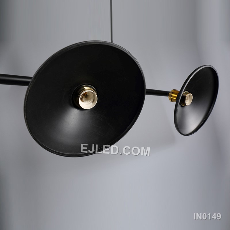 A linear steel pendant, the IN0149 features three individual barrel-shaped shades crafted from black perforated metal. Mounted along a horizontal bar, these unique enclosures diffuse light while casting subtle patterns, distinguishing it from open-cage designs. - view 5