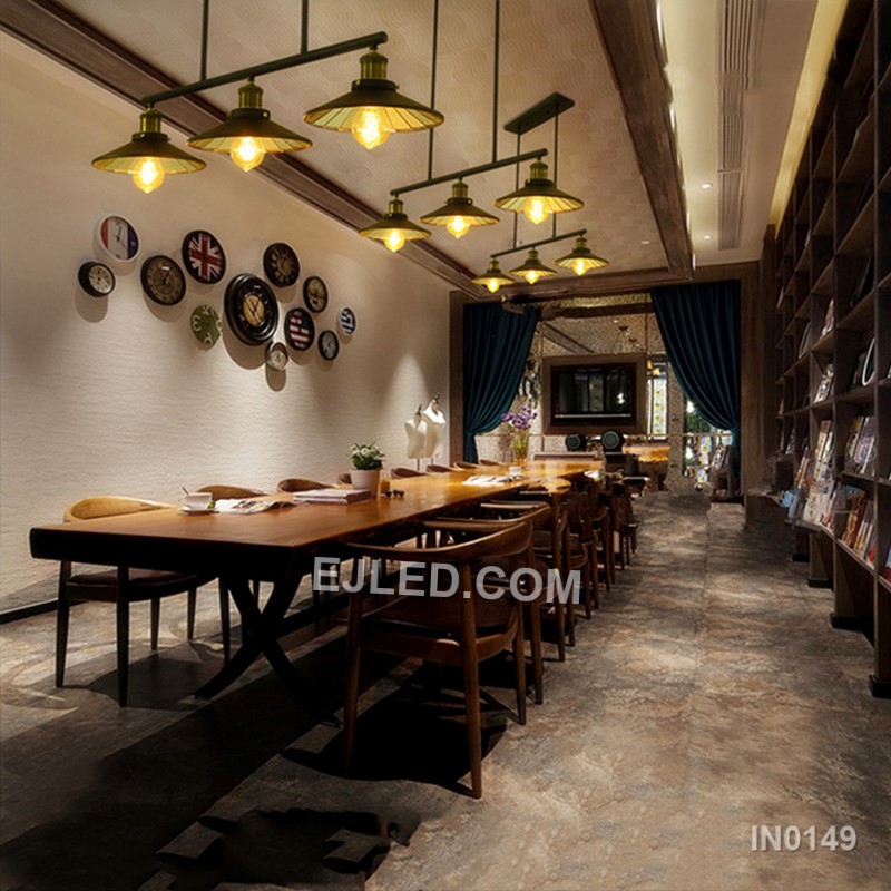 A linear steel pendant, the IN0149 features three individual barrel-shaped shades crafted from black perforated metal. Mounted along a horizontal bar, these unique enclosures diffuse light while casting subtle patterns, distinguishing it from open-cage designs. - view 7