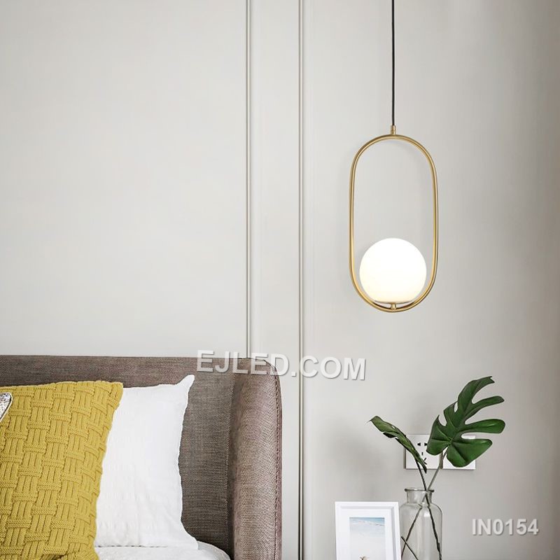 Brass and glass combine in the IN0154, a single pendant light with an open-bottom round glass shade encased by a polished brass frame. This design offers a broad, unobstructed downward light while its open frame minimises glare from the bulb. - view 3