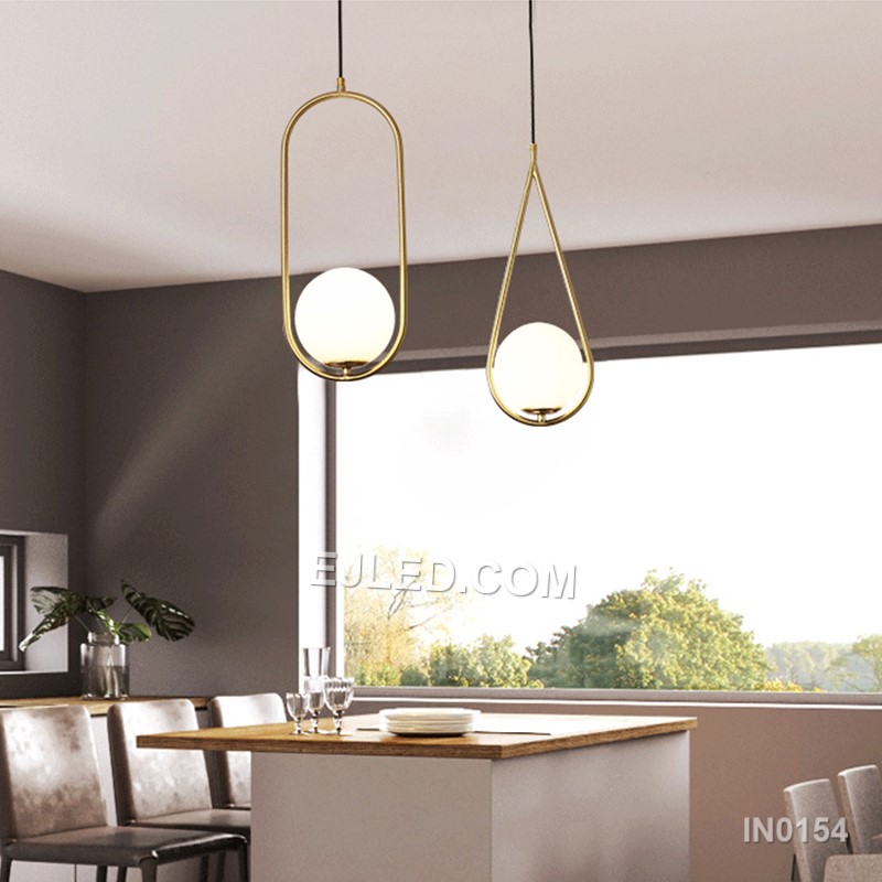 Brass and glass combine in the IN0154, a single pendant light with an open-bottom round glass shade encased by a polished brass frame. This design offers a broad, unobstructed downward light while its open frame minimises glare from the bulb. - view 6