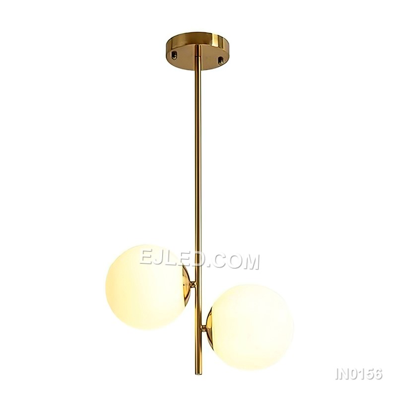 This double pendant light features two individual lamps, each with a clear round glass shade framed by polished brass. Suspended from a single rectangular canopy, it provides direct and ambient light, making it suitable for dining tables, kitchen islands, or long reception counters. - view 3