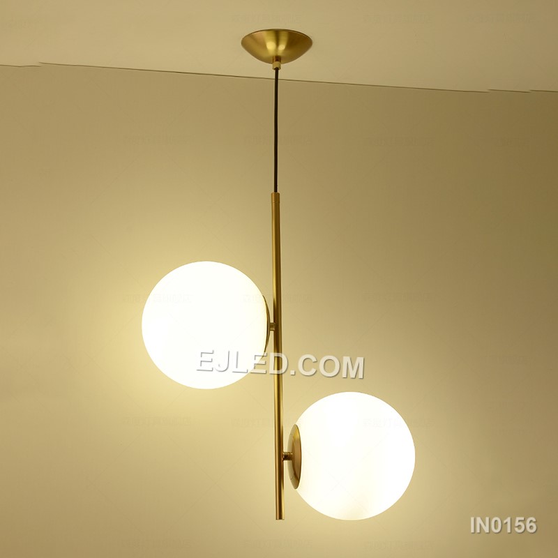 This double pendant light features two individual lamps, each with a clear round glass shade framed by polished brass. Suspended from a single rectangular canopy, it provides direct and ambient light, making it suitable for dining tables, kitchen islands, or long reception counters. - view 4