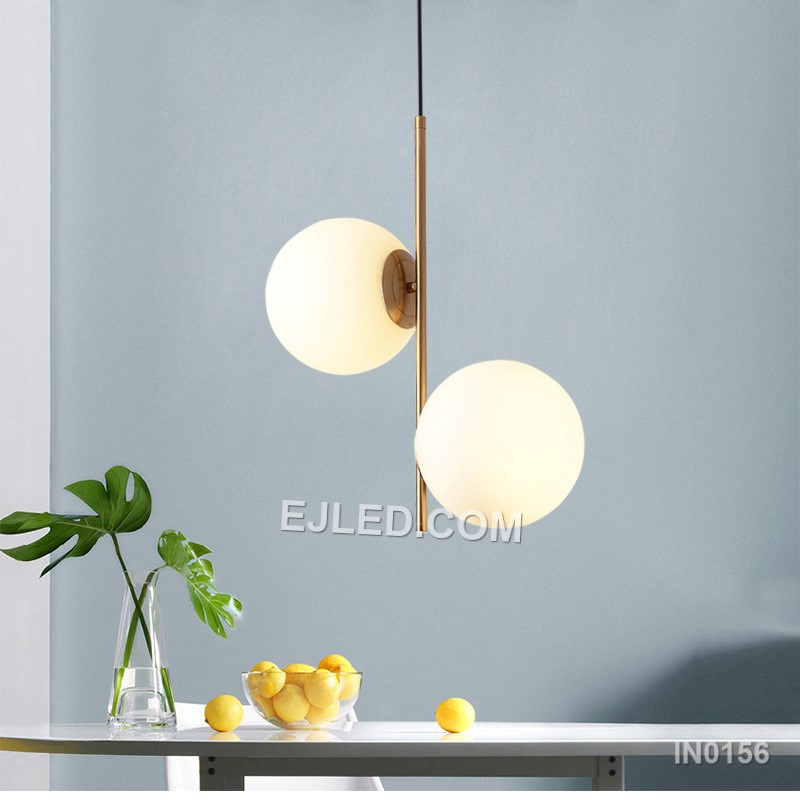 This double pendant light features two individual lamps, each with a clear round glass shade framed by polished brass. Suspended from a single rectangular canopy, it provides direct and ambient light, making it suitable for dining tables, kitchen islands, or long reception counters. - view 5