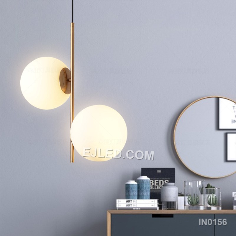This double pendant light features two individual lamps, each with a clear round glass shade framed by polished brass. Suspended from a single rectangular canopy, it provides direct and ambient light, making it suitable for dining tables, kitchen islands, or long reception counters. - view 7