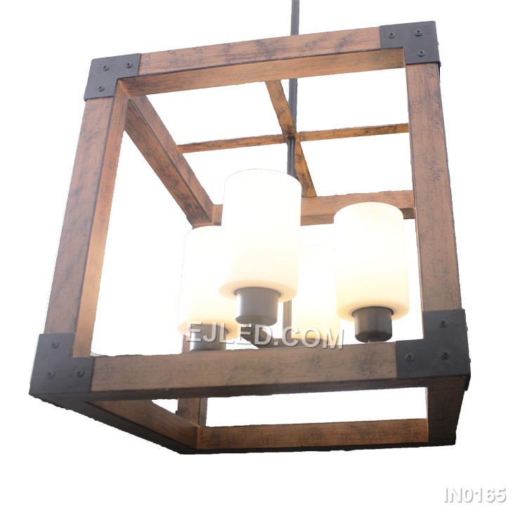 The IN0165 is a linear pendant light featuring a black iron open cage frame with a wood-finish accent bar. Three frosted, candle-shaped glass shades house the E27 bulbs, providing soft, diffused light. - view 2