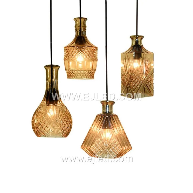 This single pendant light features an enclosed, translucent smoke-grey glass globe shade, directing a diffuse light through its spherical form. A visible lamp sits within, capped by a black and golden fixture, ideal for focused illumination in various settings.
