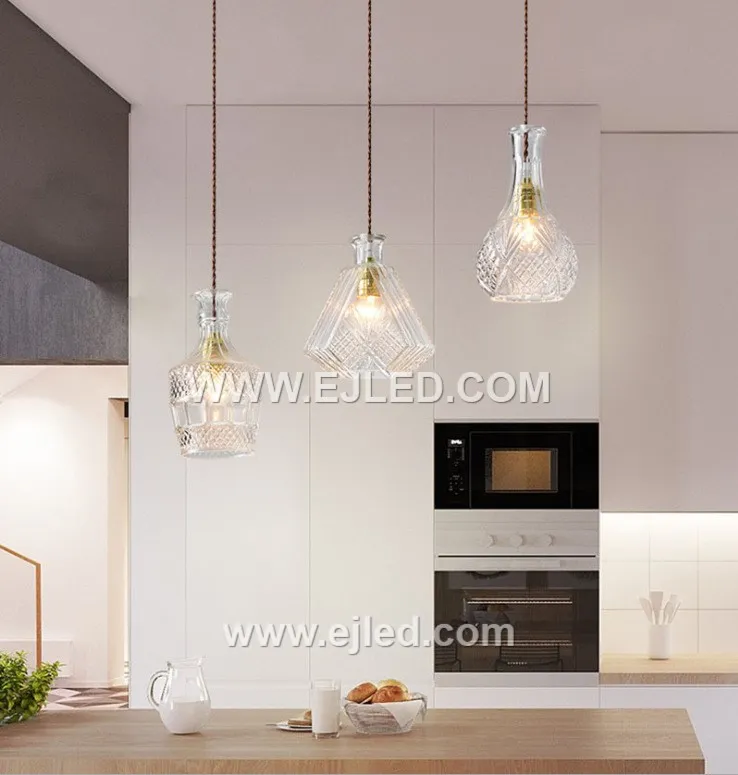This single pendant light features an enclosed, translucent smoke-grey glass globe shade, directing a diffuse light through its spherical form. A visible lamp sits within, capped by a black and golden fixture, ideal for focused illumination in various settings. - view 4