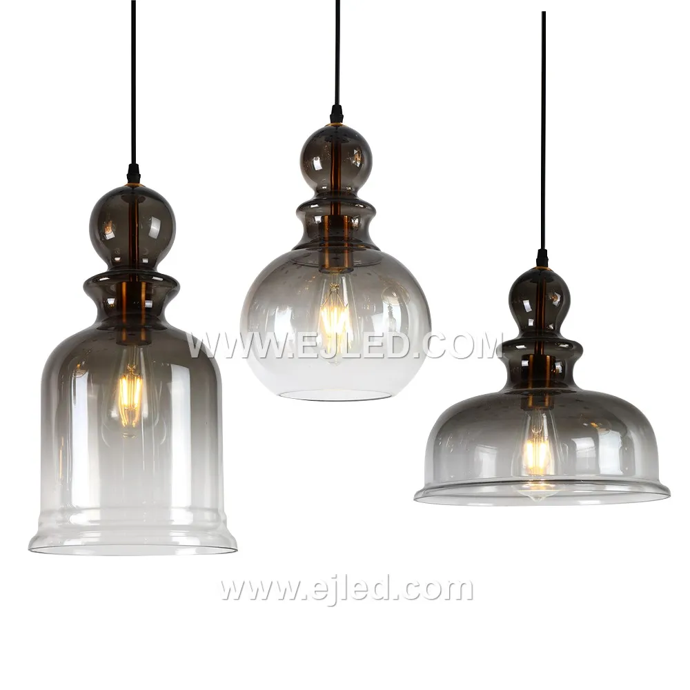 This single pendant light features a large D23*45 bell-shaped glass shade in a dark, translucent finish, offering broad, diffused illumination. Its golden-finished suspension enhances its presence.