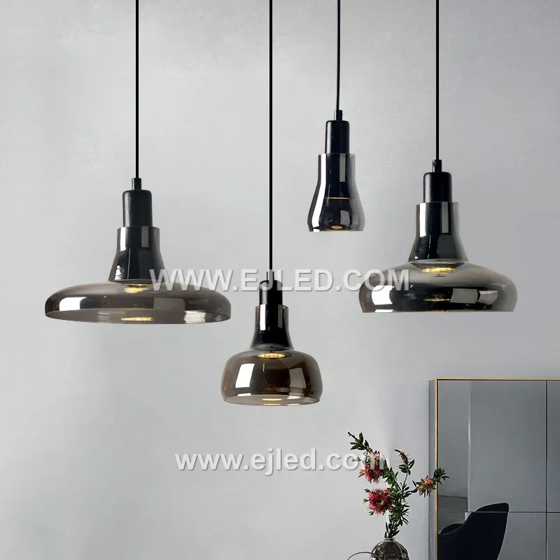 Clear glass forms the small, distinctive D9*11 cylindrical shade of the GL0007 pendant, allowing full visibility of a single decorative lamp. A golden-finished top and braided clear cable complete its minimalist design.