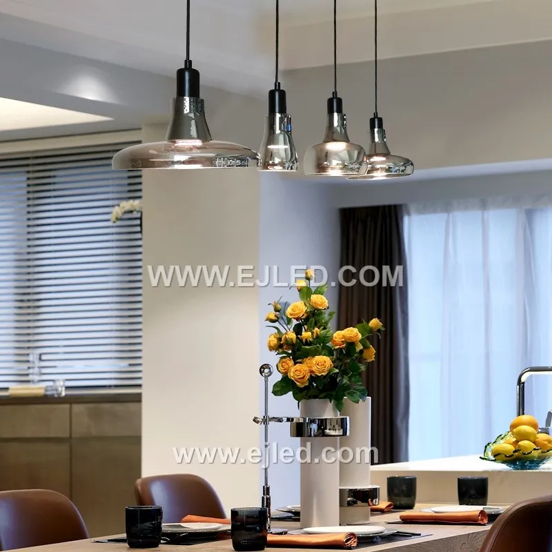 Clear glass forms the small, distinctive D9*11 cylindrical shade of the GL0007 pendant, allowing full visibility of a single decorative lamp. A golden-finished top and braided clear cable complete its minimalist design. - view 2