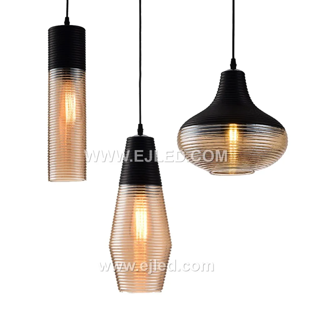 A single glass pendant light, model GL0009, illuminates spaces with a downwards glow, ideal for task lighting over kitchen islands or as accent lighting in hotel lobbies. Its cylindrical shade is crafted from black glass with a subtle golden inner hue. - view 5