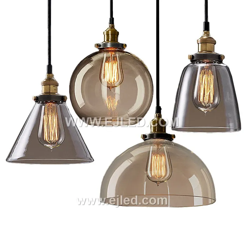 Model GL0016 features a clear, slightly flattened spherical glass shade with a wide bottom opening, accented by a substantial polished brass top. Its compact size and open design make it suitable for focused task lighting or as an accent in smaller spaces.