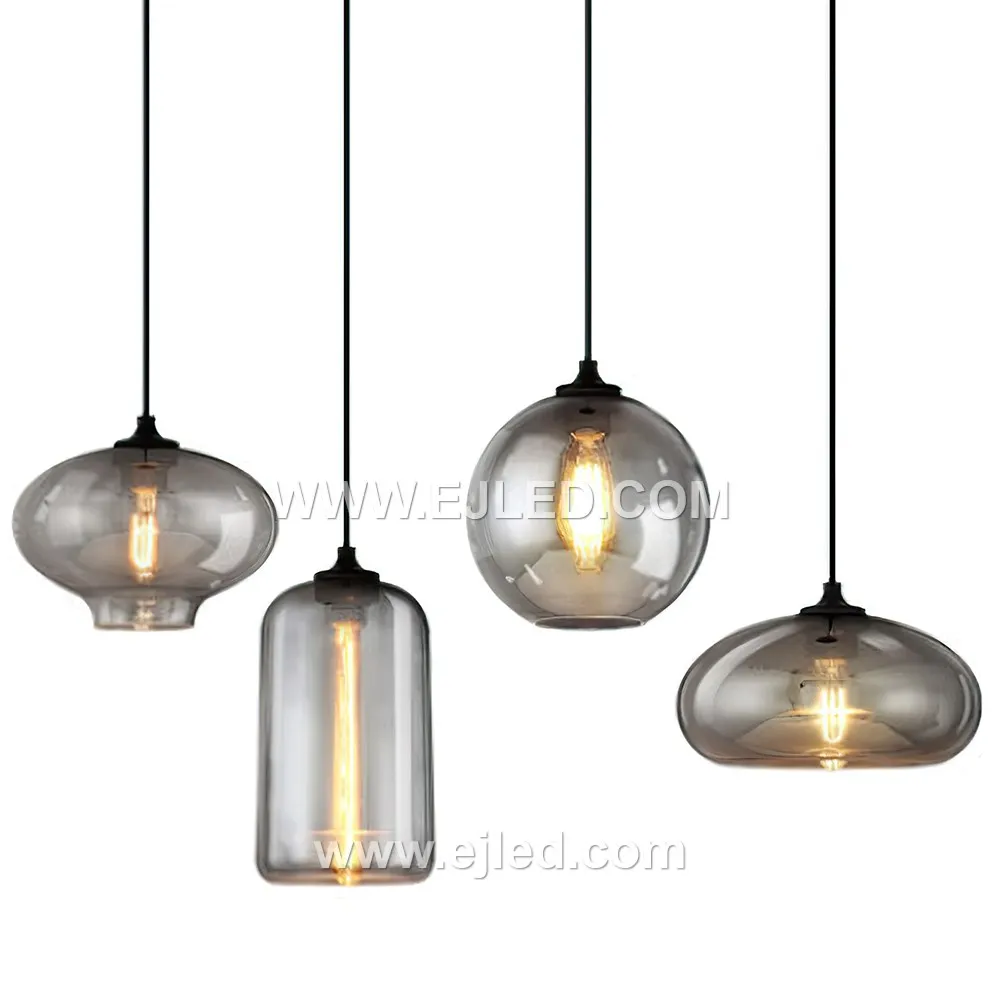 This dome-shaped glass pendant light, model GL0017, features a smoked grey finish that transitions from opaque at the top to clear at the bottom. This design effectively directs light downwards, reducing glare while highlighting the bulb within.