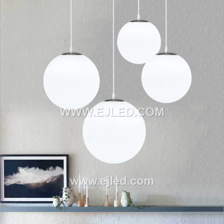 This multi-lamp pendant, model GL0020, features seven opaque white opal glass spheres suspended from a central chrome canopy. Designed to provide soft, diffused illumination, it creates a striking focal point for hospitality lobbies, stairwells, or residential dining areas. - view 2